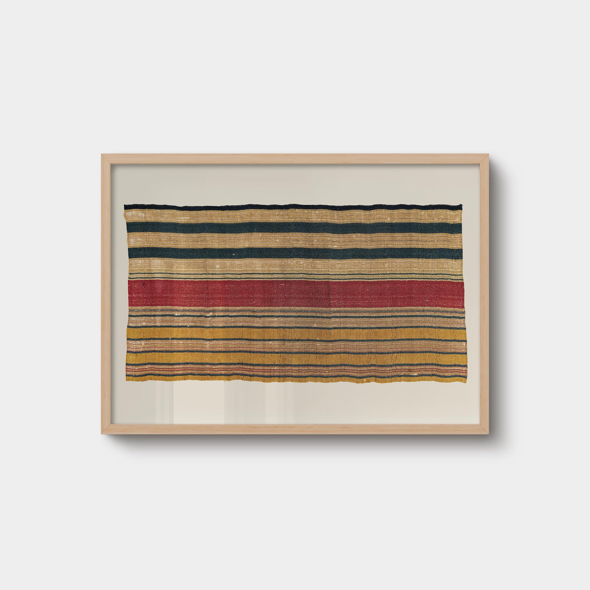 Vintage striped textile wall art print featuring woven rug-inspired patterns in rust, ochre, cream, and navy tones, displayed in a natural oak wood frame.