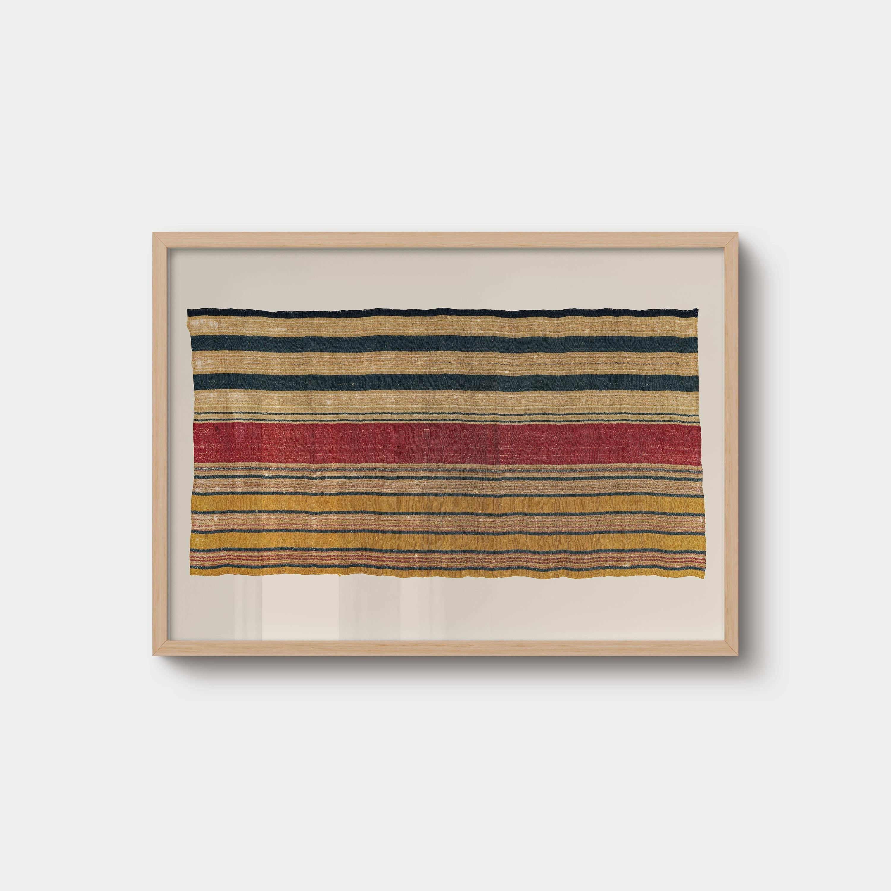 Vintage striped textile wall art print featuring woven rug-inspired patterns in rust, ochre, cream, and navy tones, displayed in a natural oak wood frame.